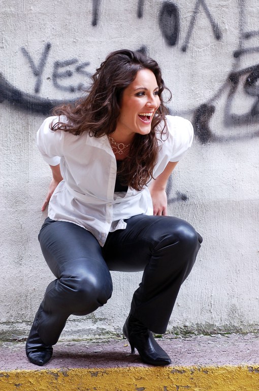 Emily in leather pants with concrete background 